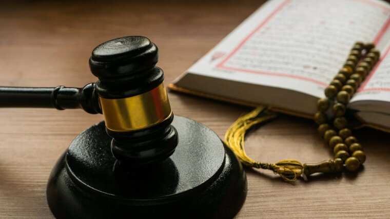Sharia or Islamic law concept with gavel, Quran and rosary beads on wooden background